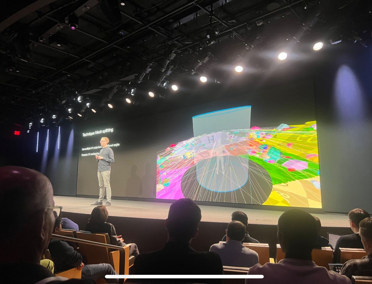 Alex Haworth presenting technical work on stage